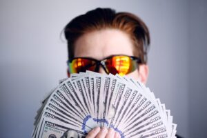 This is an Image In which a man is holding money and showing his money .In this comprehensive guide, we will explore eight lucrative online opportunities that can help you make money and achieve financial independence.